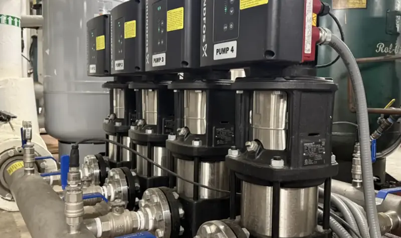 Multistage booster pump package with common discharge piping