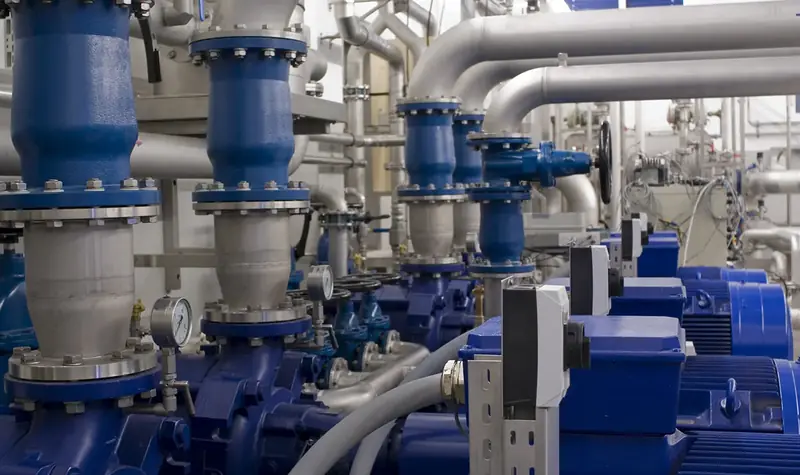 Multiple centrifugal pumps and connected piping in an industrial pump room