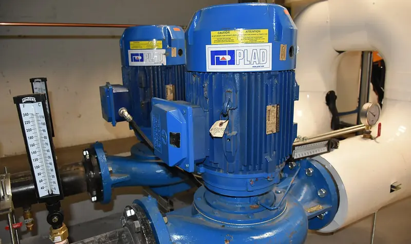 Blue vertically mounted pump and motor in a mechanical room